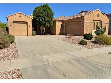 Charming single-story home featuring a well-maintained desert landscape and a spacious driveway at 2206 W Eagle Feather Rd, Phoenix, AZ 85085