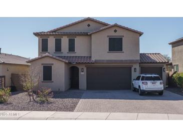 Charming two-story home featuring a tile roof, three-car garage, and desert landscaping at 25930 N Thornhill Dr, Peoria, AZ 85383