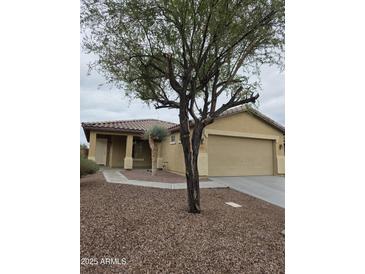 Charming single-story home with desert landscaping, a covered entryway and attached two-car garage at 5501 S Dove Crk Crk, Buckeye, AZ 85326