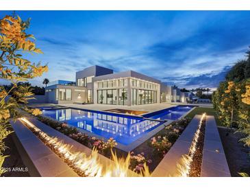 Stunning modern home with a luxurious pool and fire feature, perfect for outdoor entertaining at 6601 E San Miguel Ave, Paradise Valley, AZ 85253