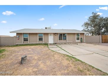 Charming single-story home featuring a well-maintained lawn and a welcoming facade at 907 N Menze St, Casa Grande, AZ 85122
