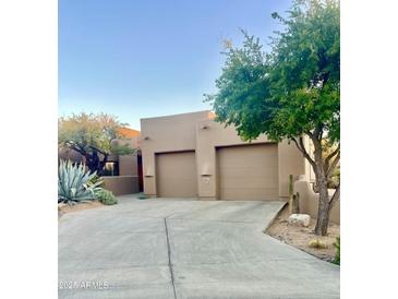 Southwest home with mature desert landscaping, and a two-car garage with a concrete driveway at 9110 E Clubhouse Ct # 639, Scottsdale, AZ 85262