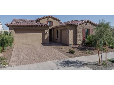 Beautiful home featuring a brick driveway, a three-car garage, and a tile roof at 11529 N 170Th Ln, Surprise, AZ 85388