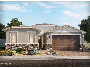 Charming single-Gathering home featuring a two-car garage, a stone veneer, and desert landscaping at 123 N 175Th Ave, Goodyear, AZ 85338