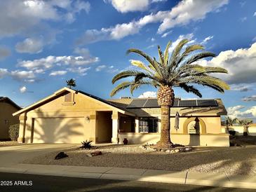 Charming home featuring a well-manicured front yard, solar panels, and inviting curb appeal at 14510 W Yosemite Dr, Sun City West, AZ 85375