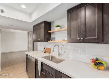 Charming kitchen with stainless steel appliances, undermount sink, stylish cabinets, and hardwood floors at 1517 E Dunbar Dr, Tempe, AZ 85282