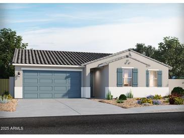 Charming single-story home featuring desert landscaping, a two-car garage, and a welcoming entryway at 168 S 177Th Ln, Goodyear, AZ 85338