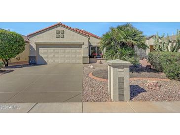 Charming single-story home with a well-maintained front yard, desert landscaping, and an attached two-car garage at 17210 N Firestone Ln, Surprise, AZ 85374