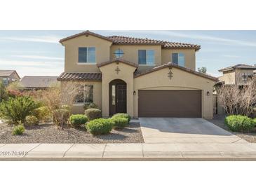 Inviting two-story home with a tile roof, a two-car garage, and low-maintenance desert landscaping at 18811 W San Miguel Ave, Litchfield Park, AZ 85340