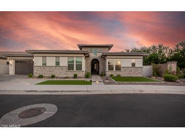 Striking single-story home featuring stone accents, manicured landscaping, and a barrel roof in a serene neighborhood at 1925 E La Costa Dr, Gilbert, AZ 85298