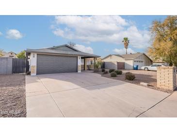 Single-story home with a spacious driveway and well-maintained landscaping at 2016 N Pennington Dr, Chandler, AZ 85224