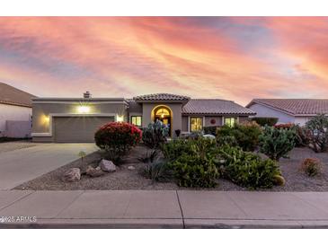 Charming home with desert landscaping, vibrant plants, and an inviting covered entry at sunset at 2169 E Alameda Dr, Tempe, AZ 85282