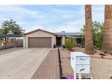 Charming single-Gathering home with a well-maintained front yard and two-car garage at 2744 E Windrose Dr, Phoenix, AZ 85032