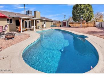 Sparkling pool and back yard, perfect for outdoor entertaining and relaxation on a sunny day at 4201 W Brown St, Phoenix, AZ 85051