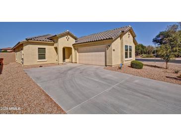 Charming home featuring a two-car garage and a well-maintained front yard at 45322 W Sandhill Rd, Maricopa, AZ 85139