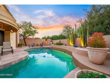 Inviting backyard oasis featuring a private pool, mature desert landscaping, and an outdoor dining area at 7705 E Doubletree Ranch Rd # 29, Scottsdale, AZ 85258