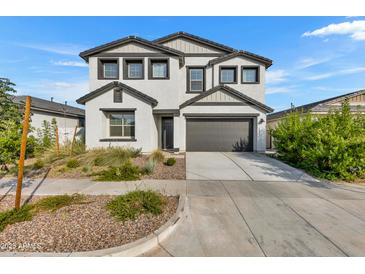 Charming two-story home featuring a two-car garage and a well-maintained front yard at 9759 E Satellite Dr, Mesa, AZ 85212