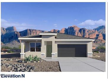 Charming single-story home with a desert landscape and attached two-car garage offers style and functionality at 10643 W Sonrisas St, Tolleson, AZ 85353