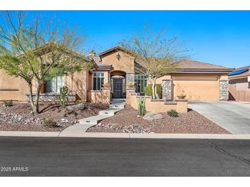 Charming single-story home featuring a landscaped front yard and a welcoming front entrance at 1320 W Whitman Dr, Anthem, AZ 85086