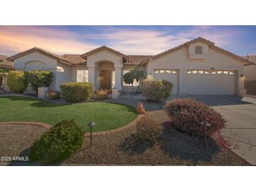 Charming single-story home featuring manicured landscaping and a spacious two-car garage at 14955 N 78Th Dr, Peoria, AZ 85381