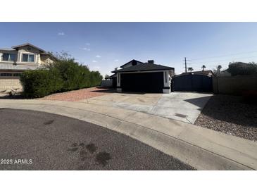 Charming single-Gathering home with a black garage door and a well-maintained front yard at 18829 N 15Th Pl, Phoenix, AZ 85024