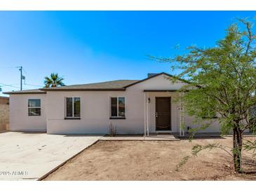 Charming single-story home featuring a well-maintained exterior and a neatly landscaped front yard at 3035 W Pierce St, Phoenix, AZ 85009