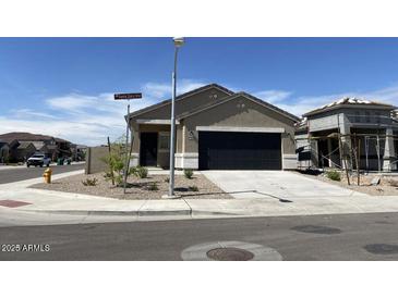 Charming single-story home featuring a two-car garage and low-maintenance landscaping at 36638 W Santa Clara Ave, Maricopa, AZ 85138