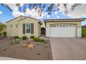 Charming single-story home featuring a two-car garage and desert landscaping at 5189 N 206Th Dr, Buckeye, AZ 85396