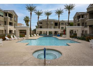 Community pool and lounge area surrounded by palm trees offering a relaxing outdoor retreat at 5303 N 7Th St # 101, Phoenix, AZ 85014