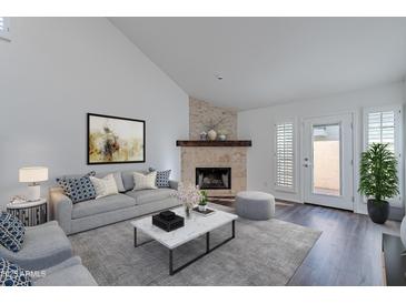 Cozy living room featuring a stone fireplace and comfortable seating at 6223 N 12Th St # 8, Phoenix, AZ 85014