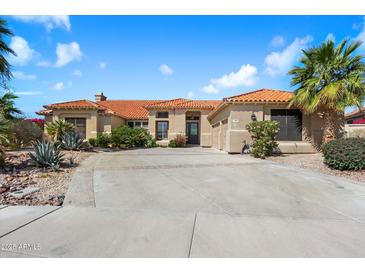 Charming single-story home with a red tile roof, desert landscaping and a spacious driveway at 9098 N 117Th Way, Scottsdale, AZ 85259