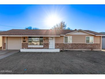 Charming single-story home with a brick accent and a well-lit facade at 12211 N 25Th Ave, Phoenix, AZ 85029