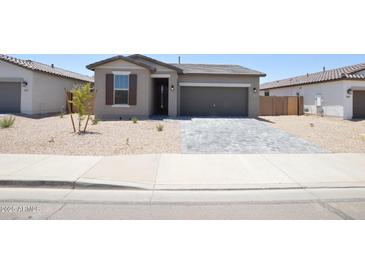Charming single-story home with gray stucco and a well-manicured, xeriscaped front yard at 1661 N St Francis Pl, Casa Grande, AZ 85122