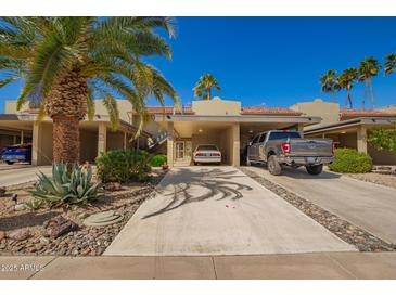 Inviting home exterior showcasing desert landscaping, shade cover parking, and vibrant blue sky background at 19610 N Star Ridge Dr, Sun City West, AZ 85375