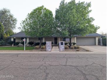 Charming home featuring mature landscaping, a brick facade, and a welcoming entrance at 4145 E Libby St, Phoenix, AZ 85032