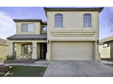 Two story home featuring neutral stucco, a tile roof and attached two car garage at 4552 S 238Th Ln, Buckeye, AZ 85326