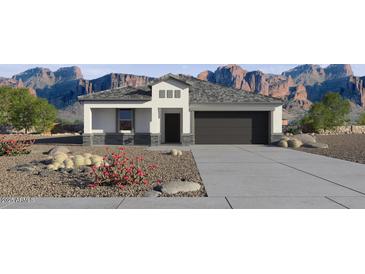 Charming single-story home featuring desert landscaping and a two-car garage against a scenic mountain backdrop at 469 N 17Th St, Coolidge, AZ 85128