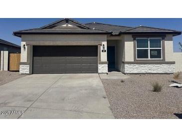 Charming single story home with a two car garage and desert landscaping at 481 N 17Th St, Coolidge, AZ 85128