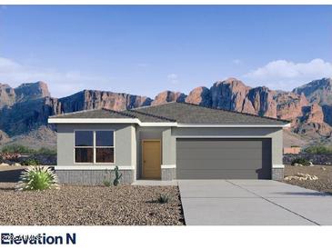 Beautiful single-story home with neutral tones, two-car garage, desert landscaping and mountain views at 5005 S 106Th Ave, Tolleson, AZ 85353