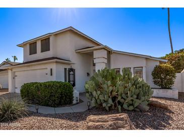 Charming home features a desert landscape, beautiful walkway, and an inviting covered entrance at 605 W Kings Ave, Phoenix, AZ 85023