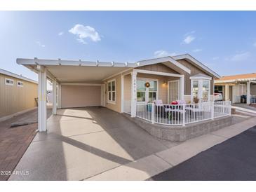 Charming home with a covered carport and cozy front porch, perfect for relaxing at 650 N Hawes Rd # 2873, Mesa, AZ 85207