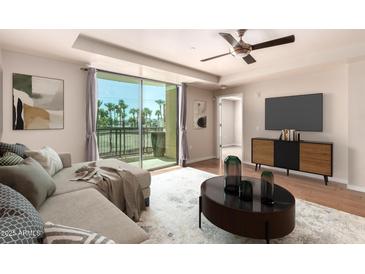 Inviting living room boasts a sliding glass door, ceiling fan, and modern furniture at 6803 E Main St # 3306, Scottsdale, AZ 85251