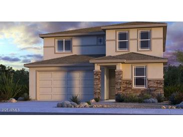 Two-story home showcasing a 2-car garage, stone accents, and a mix of window styles at 8817 W Windsor Blvd, Glendale, AZ 85305