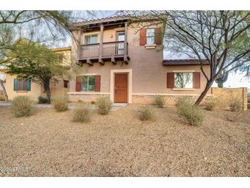 Inviting two-story home featuring a charming balcony and desert landscaping at 10421 W Via Del Sol -- # 379, Peoria, AZ 85383