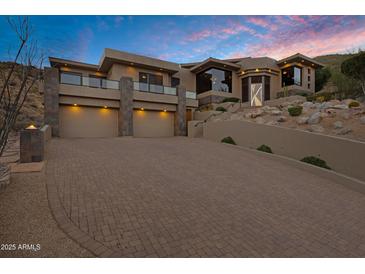 Stunning multi-level home with a three-car garage and beautiful desert landscaping at 14725 N Mariposa Ct, Fountain Hills, AZ 85268
