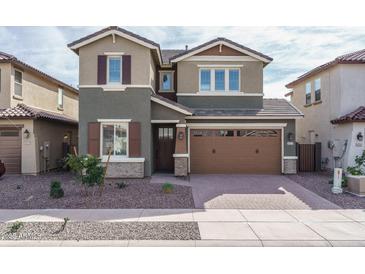Two-story home featuring a two-car garage, low maintenance landscaping, and neutral color palette at 16227 W Mariposa Grande --, Surprise, AZ 85387
