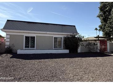 Charming single-story home with a gray roof and xeriscaped front yard at 2349 W Shaw Butte Dr, Phoenix, AZ 85029