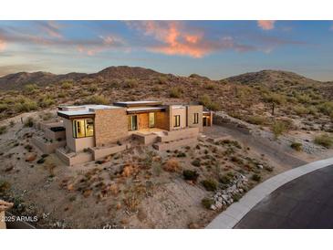 Expansive desert home featuring a modern design with stacked stone accents and ample privacy at 26885 N 87Th Dr, Peoria, AZ 85383