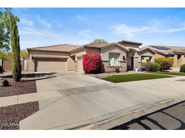 Charming single-story home with a two-car garage, manicured landscaping and a beautiful tiled roof at 27016 N 20Th Ln, Phoenix, AZ 85085