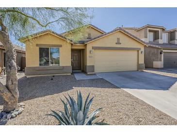 Charming single-story home featuring low-maintenance desert landscaping and a two-car garage at 36307 W El Greco St, Maricopa, AZ 85138
